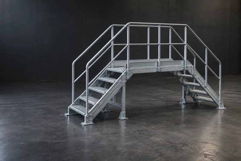 A custom metal industrial stepover platform with stairs and handrails