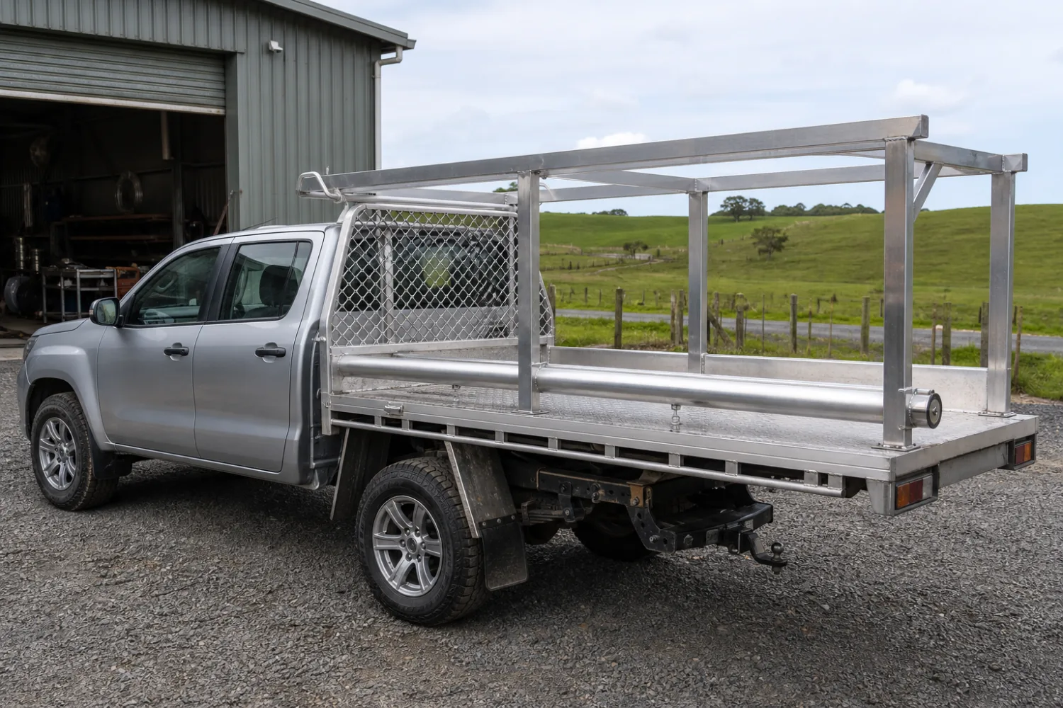 Custom fabricated aluminium ladder rack and headboard fitted to a flat-deck ute tray, made by Specialised Stainless