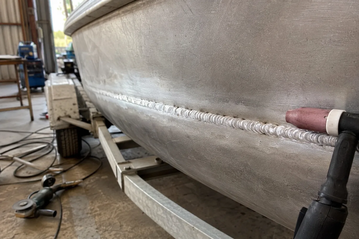 TIG welding repair on a cracked aluminium boat hull in the Specialised Stainless workshop