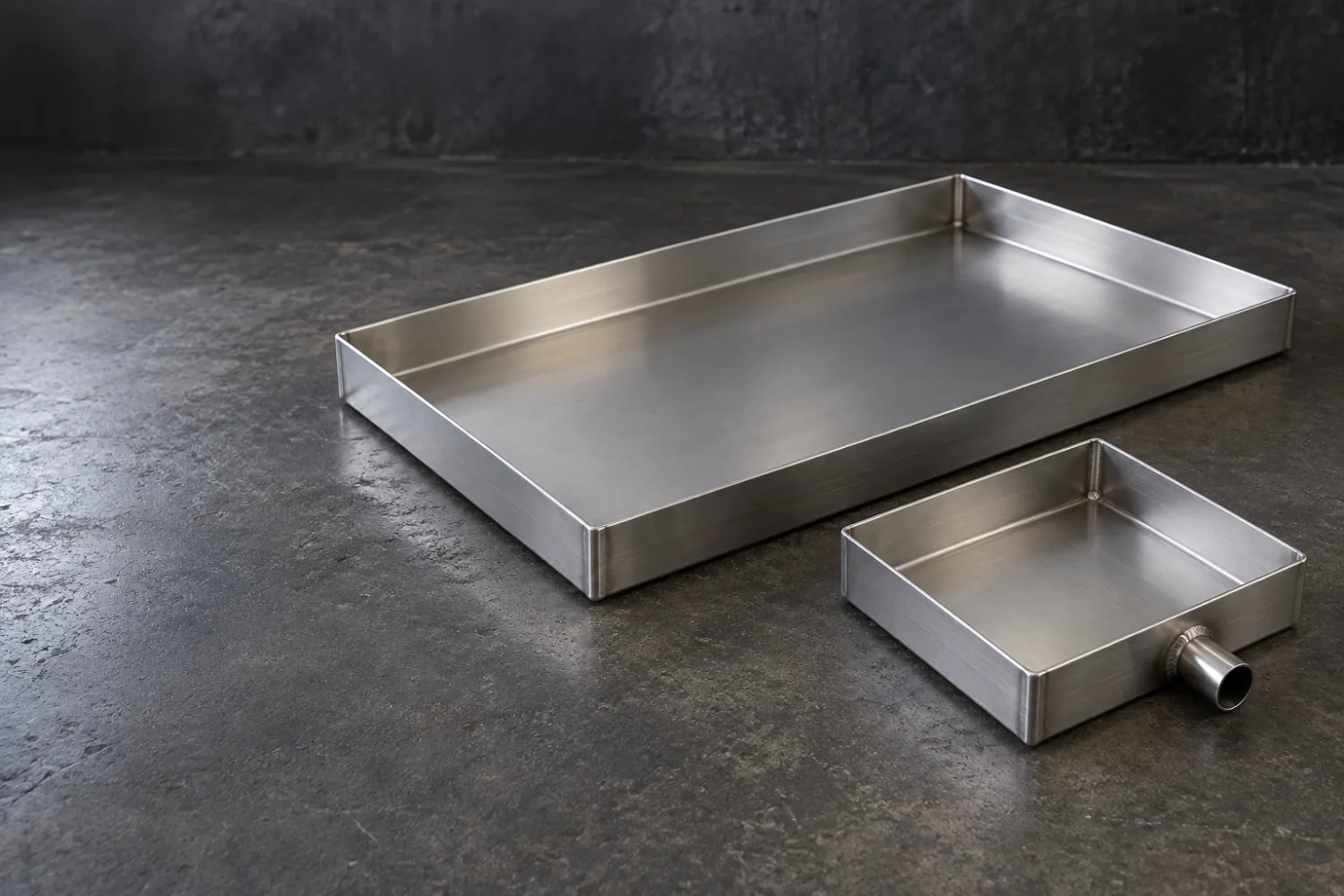 Concept illustration of a stainless catch tray with folded edges and a removable grate